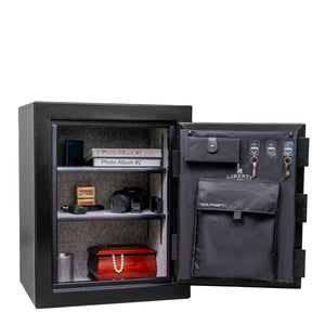 Liberty Home 8 safe, door open, displaying a compact interior with adjustable shelves and door organizer for jewelry, documents, or handguns.